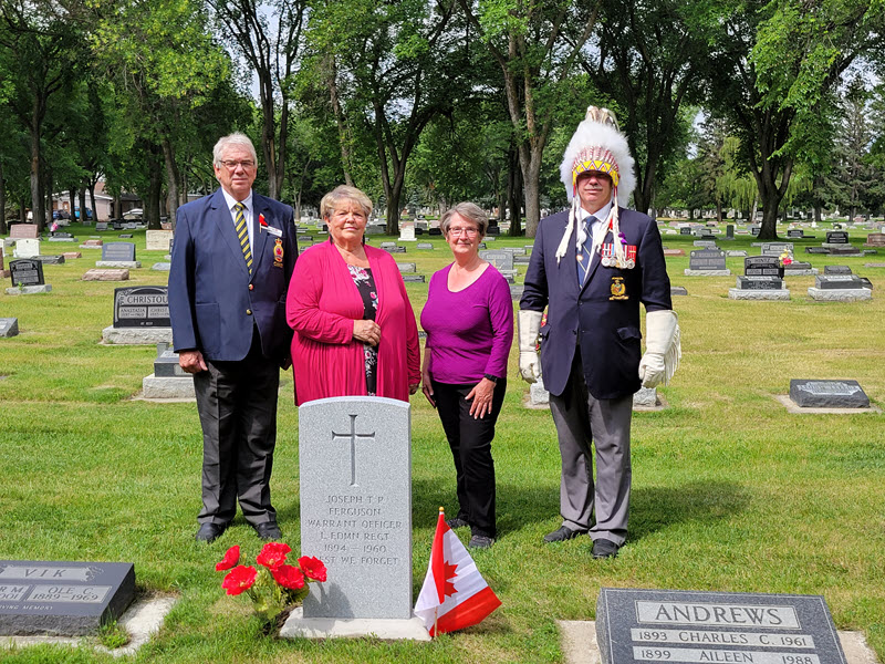 Group at gravestone provided by the Last Post Fund