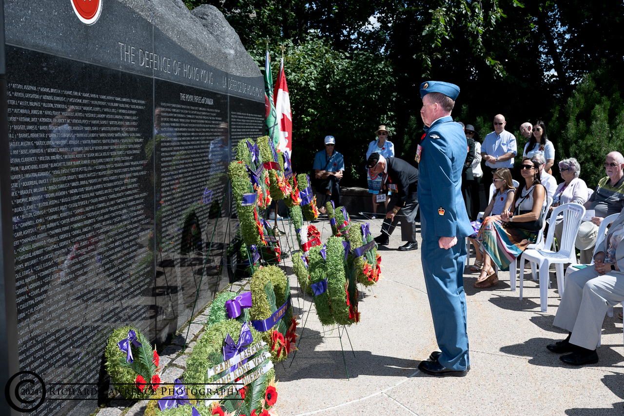 Image: Warrant Officer Stephen James, grandson, laying wreath for Hong Kong 
		Veteran John James