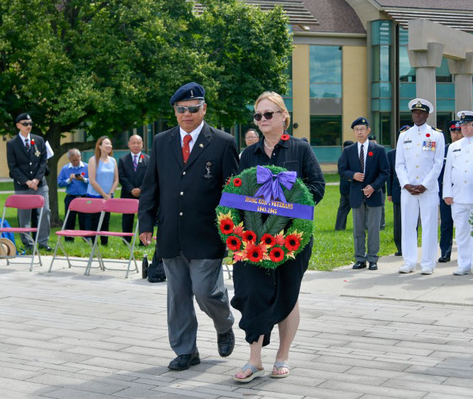 Image: Judi Denison, daughter of Elmer Denison (RRC) and niece 
					of Everette Denison (RRC) laying HKVCA wreath