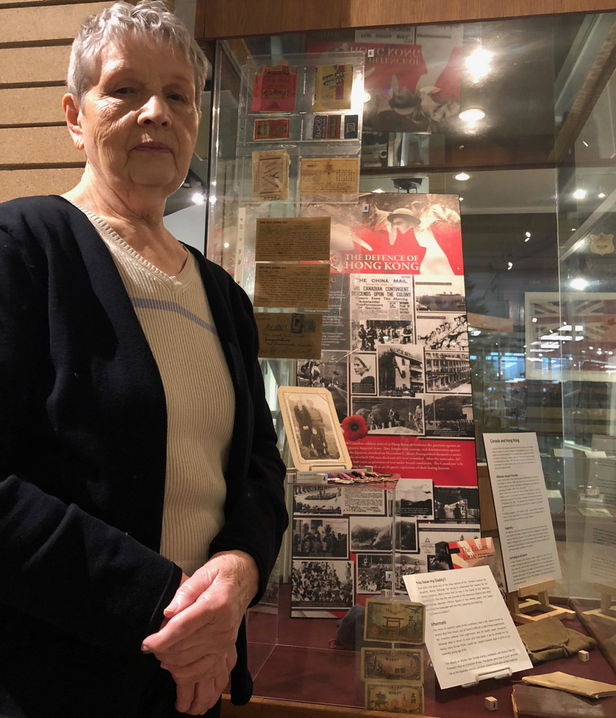 Mona Thornton with some of her father's personal belongings beside the HKVCA Commemorative Plaque that are on display at the Penticton Museum. Photo supplied by the Penticton Herald
