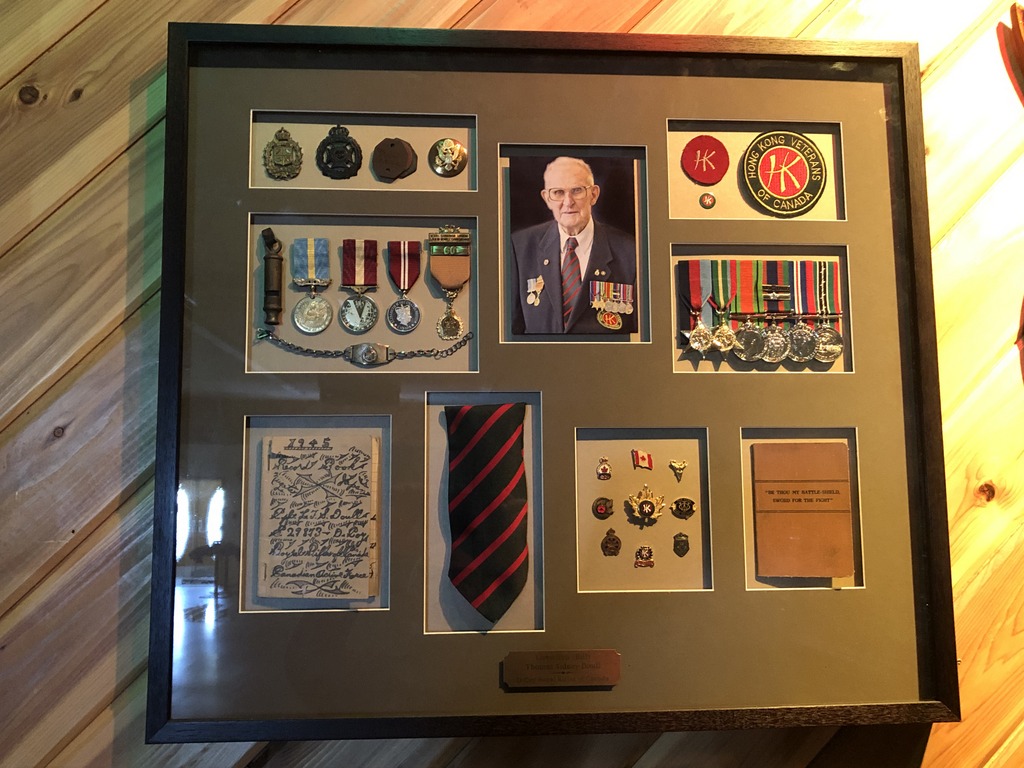 Shadow box displaying medals and insignia of 'C' Force veteran Llewellyn (Bill) Doull