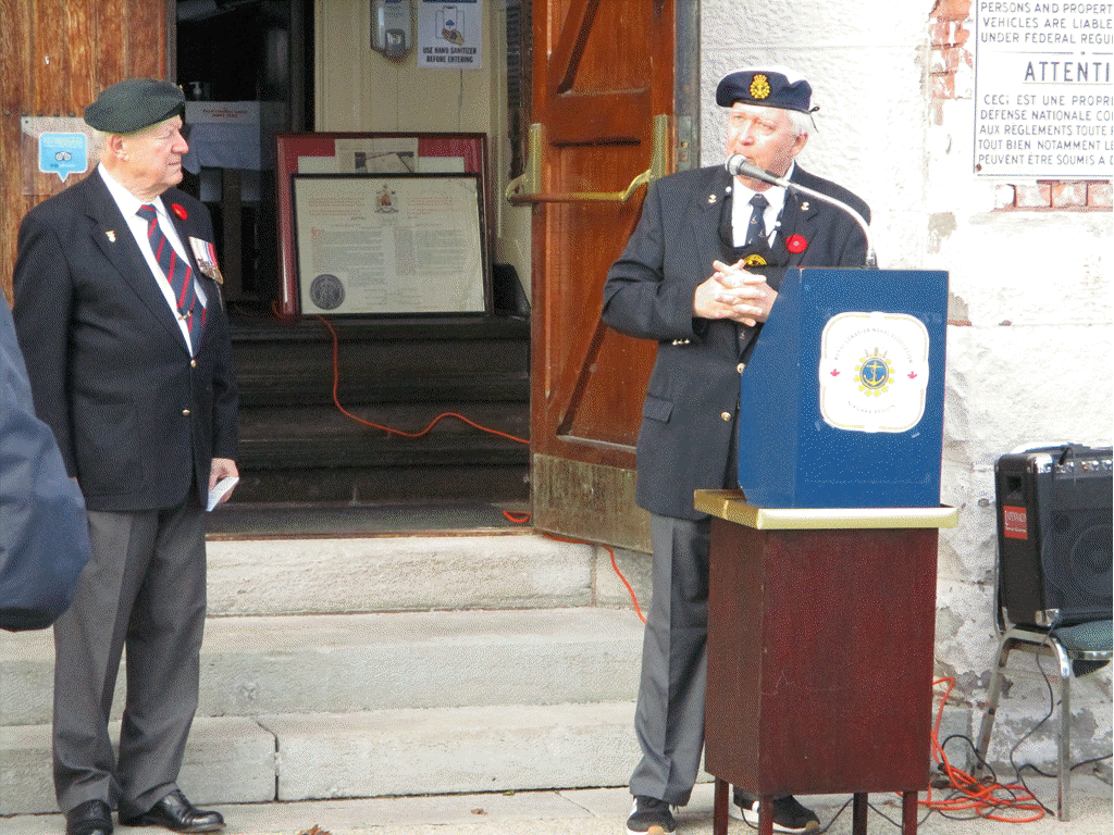 Niagara Military Museum President Jim Doherty delivering the 
				opening introduction to the event with LCol Bernard Nehring (Ret’d) 
				at the left of the photo