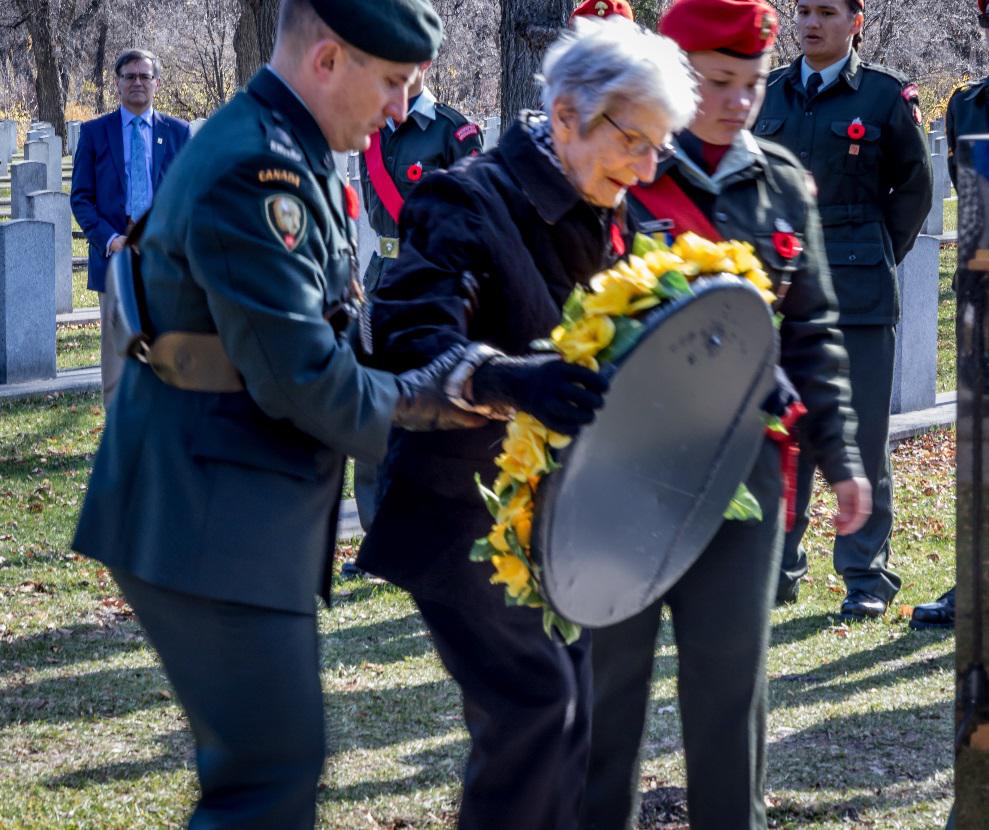 Ladena Hogkinson Mabley (HK widow) laying the wreath escorted by Lt Col. Moran, 38th Brigade Cdn Armed Forces and a Winnipeg Grenadiers cadet.  
