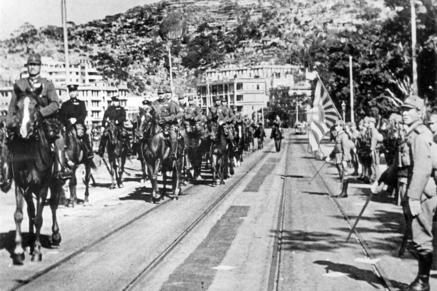 Japanese forces parade through Hong Kong in 1942 on horseback.